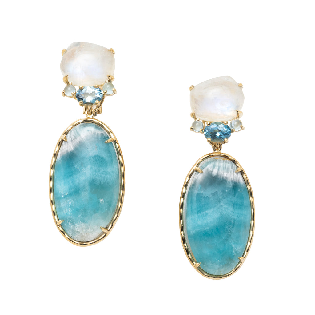Pair of earrings with blue and white stones set in yellow gold on a white background