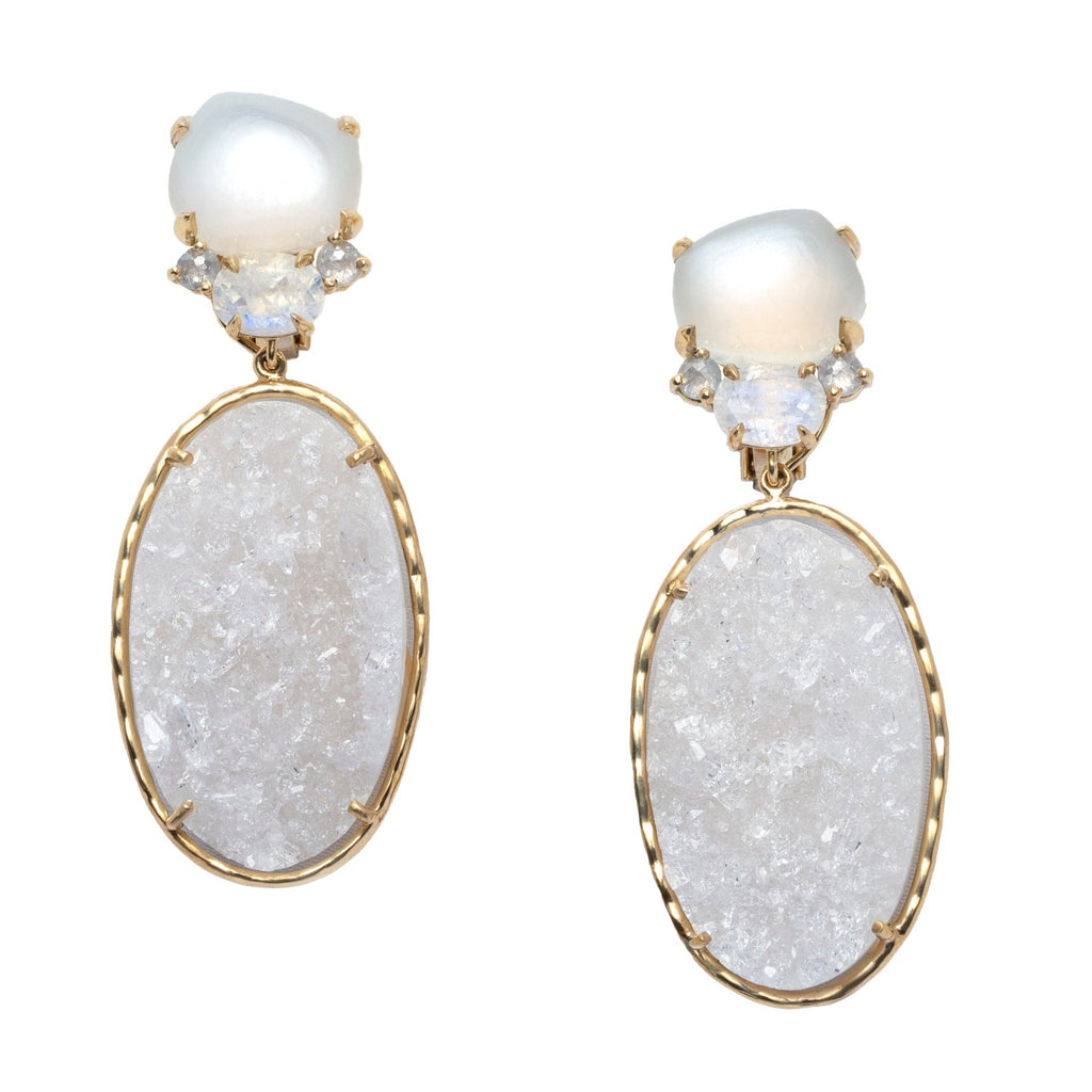 Pair of earrings with white stones set in yellow gold on a white background