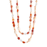A long necklace of king conch, carnelian and mexican jelly opal beads with a clasp of whiskey-hued zircon and 18k yellow gold. 