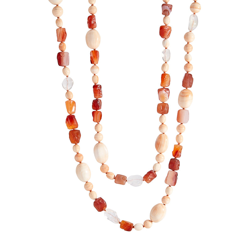 A long necklace of king conch, carnelian and mexican jelly opal beads with a clasp of whiskey-hued zircon and 18k yellow gold. 