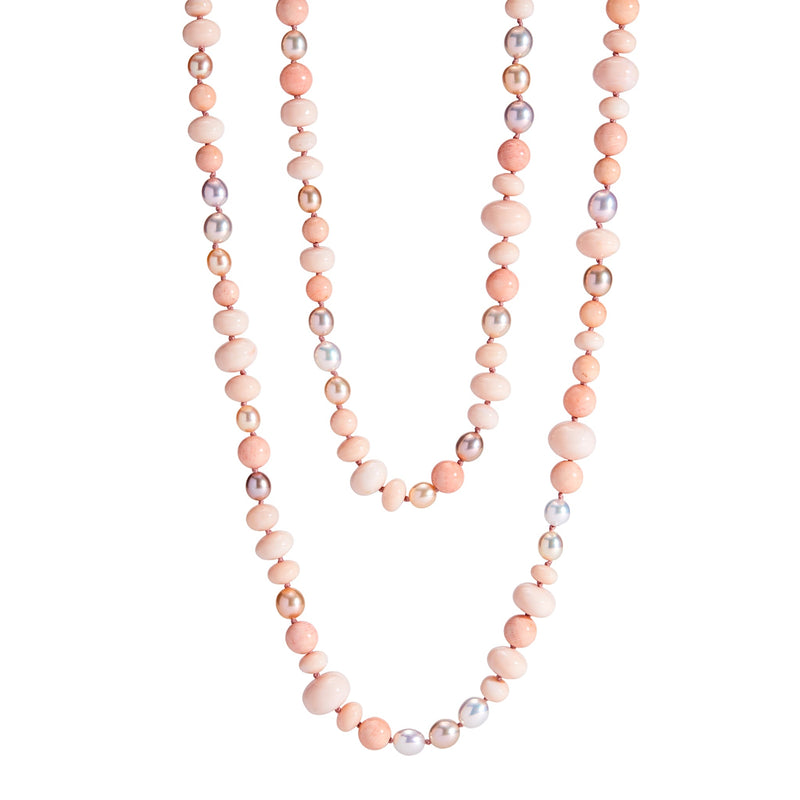 A long necklace of coral, freshwater pearls, and peach opal with a tri-cornered freshwater pearl clasp set in 18k yellow gold.