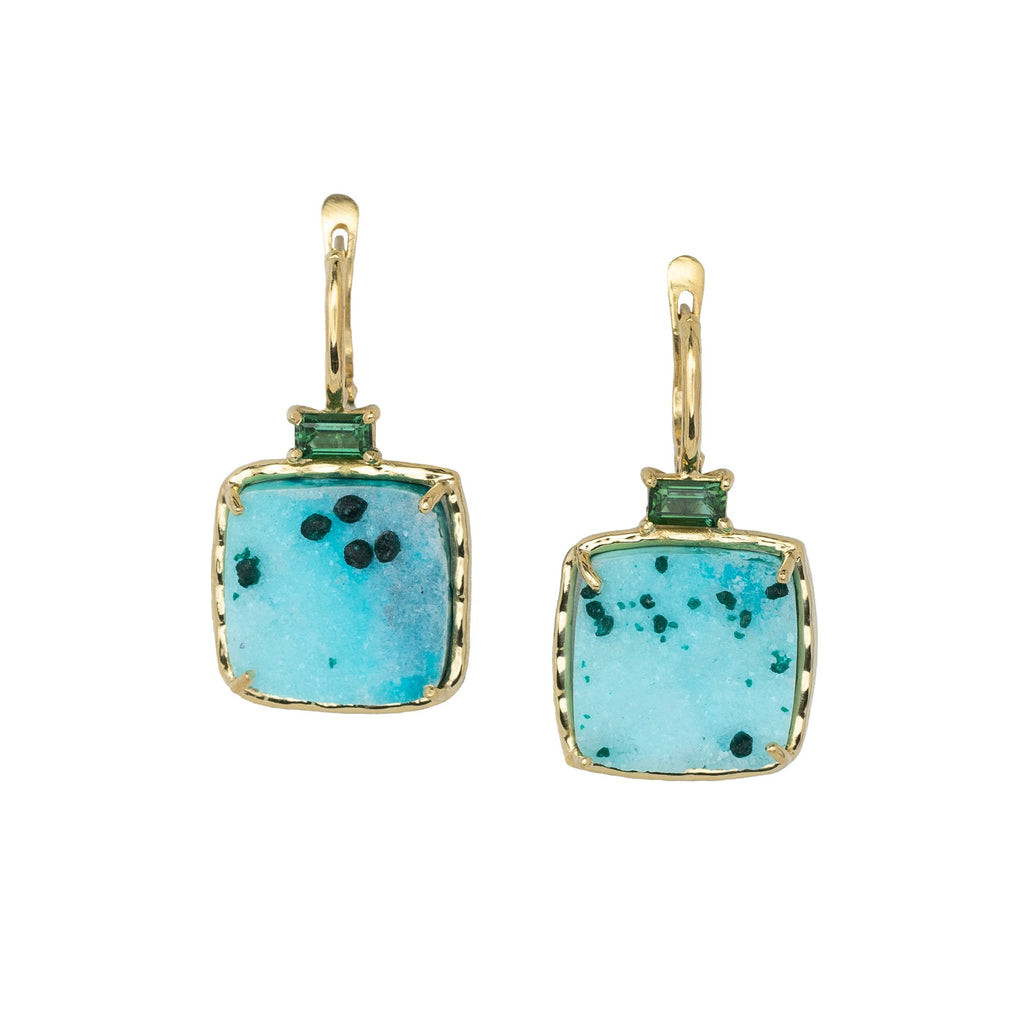 Pair of earrings with turquoise square stones and gold accents on a white background