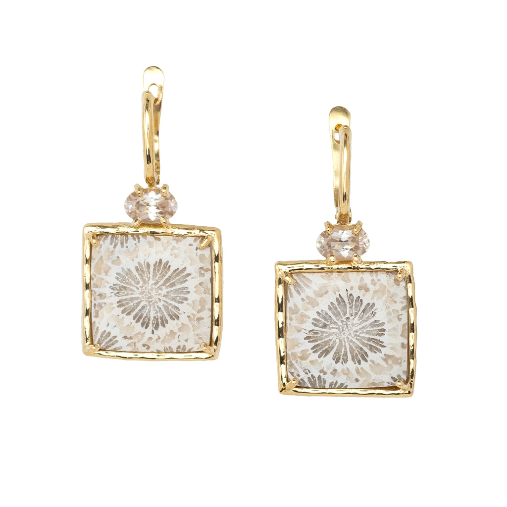 Gold-framed square earrings with silvery white fossilized coral floral design on a white background